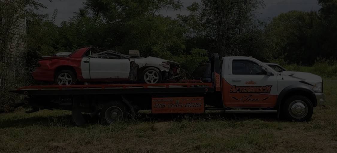 Aftershock Tow flatbed truck carrying a recovered vehicle